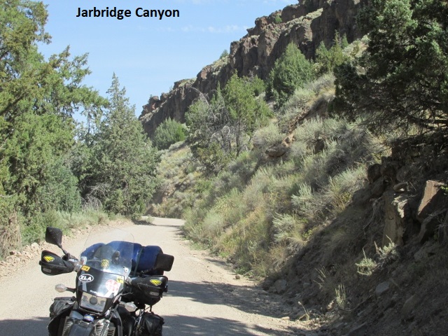 A motorcycle parked on a dirt road

Description automatically generated with medium confidence